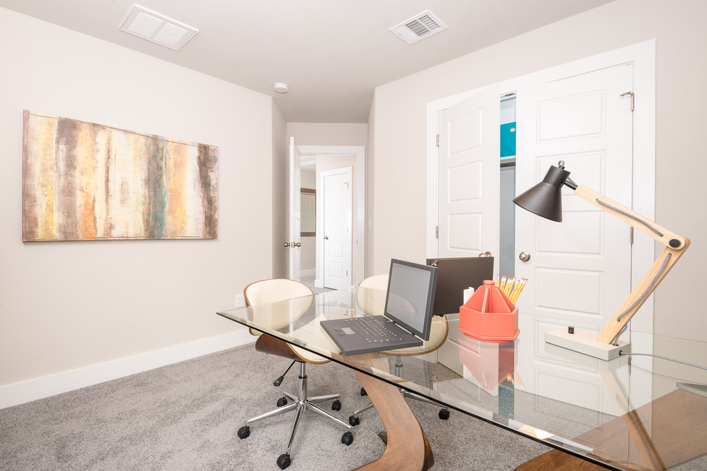 Mittelgroßes Modernes Arbeitszimmer ohne Kamin mit freistehendem Schreibtisch, beiger Wandfarbe und Teppichboden in Austin