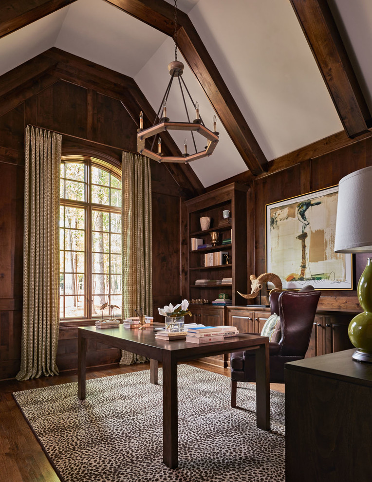 Country study in Charlotte with dark hardwood flooring and a freestanding desk.