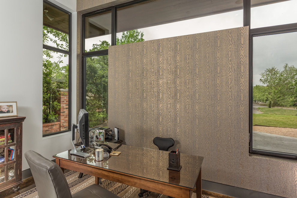 This is an example of a contemporary home office in Austin with brown walls.