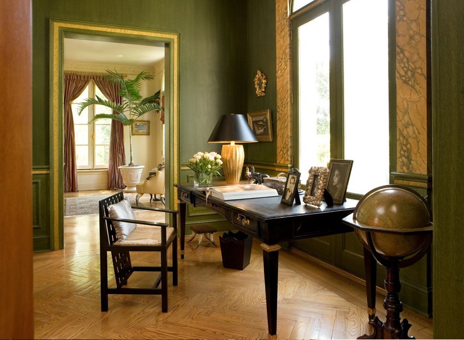 Foto de estudio clásico pequeño con paredes verdes, suelo de madera en tonos medios, escritorio independiente y suelo marrón