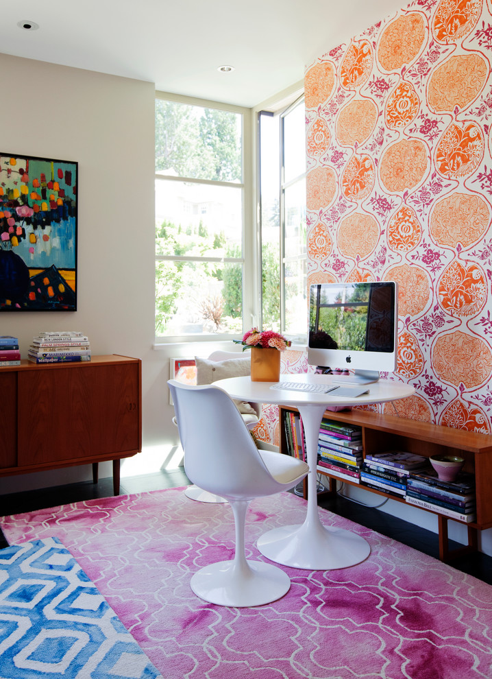 This is an example of a large modern home studio in Vancouver with multi-coloured walls and a freestanding desk.