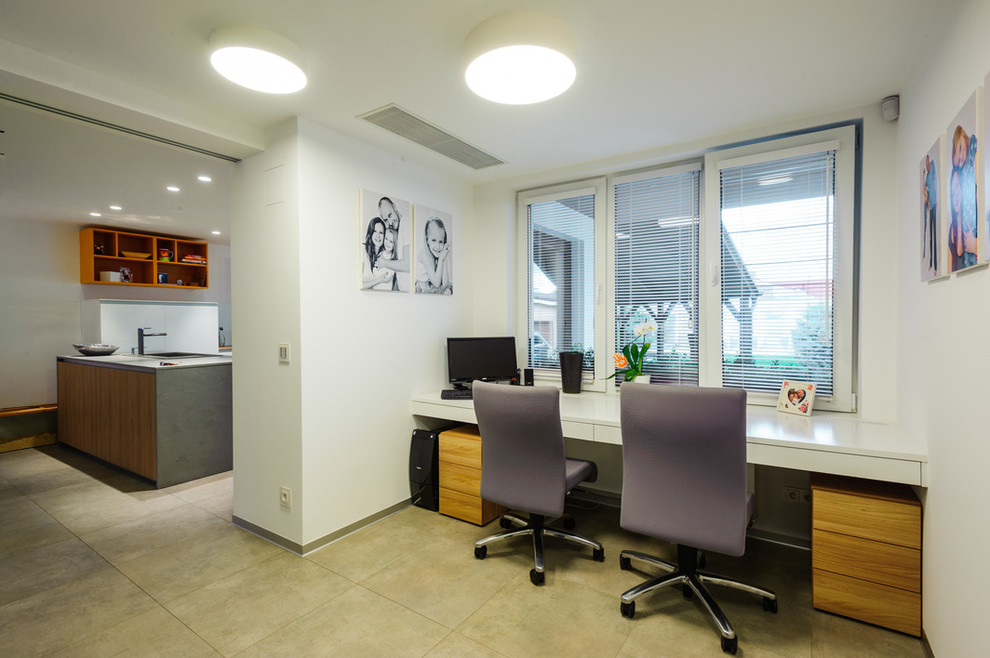 Imagen de despacho moderno pequeño sin chimenea con paredes blancas, suelo de baldosas de cerámica y escritorio empotrado