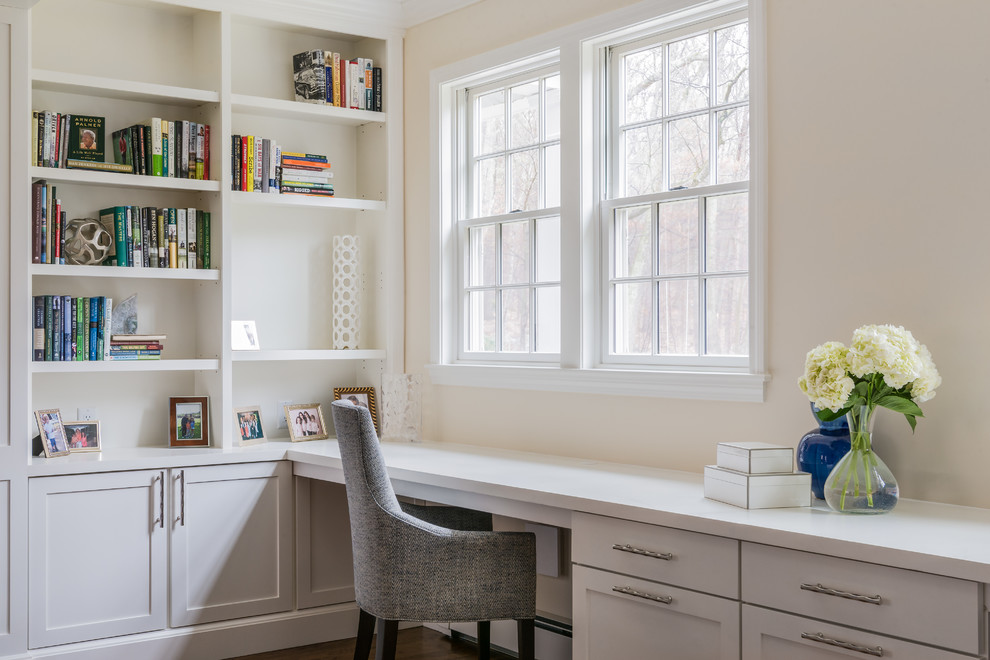 Design ideas for a medium sized classic home office in Boston with medium hardwood flooring, a standard fireplace, a stone fireplace surround, brown floors and beige walls.