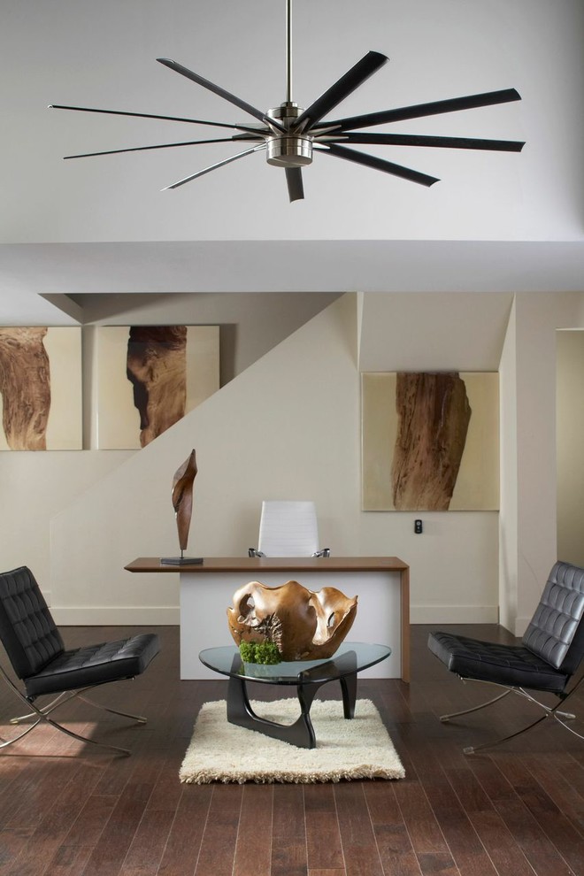 Mid-sized urban built-in desk medium tone wood floor study room photo in San Diego with white walls and no fireplace