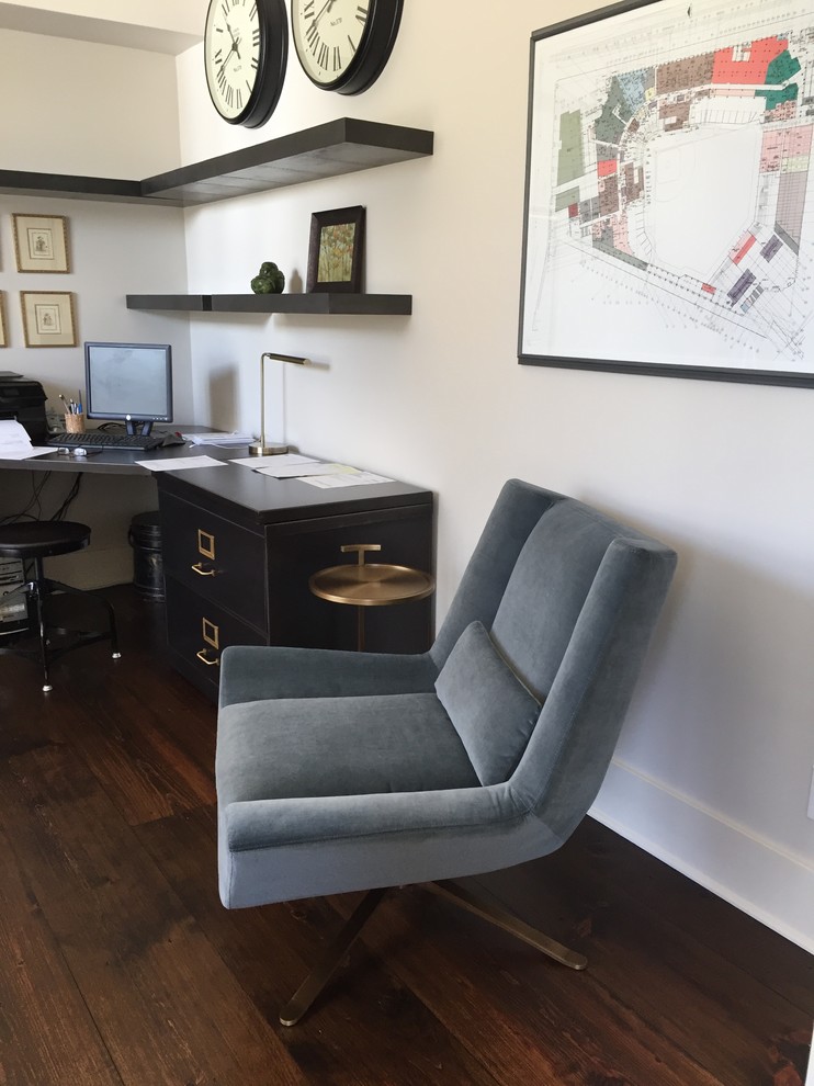 Example of a mid-sized urban freestanding desk dark wood floor and brown floor study room design in Raleigh with white walls and no fireplace