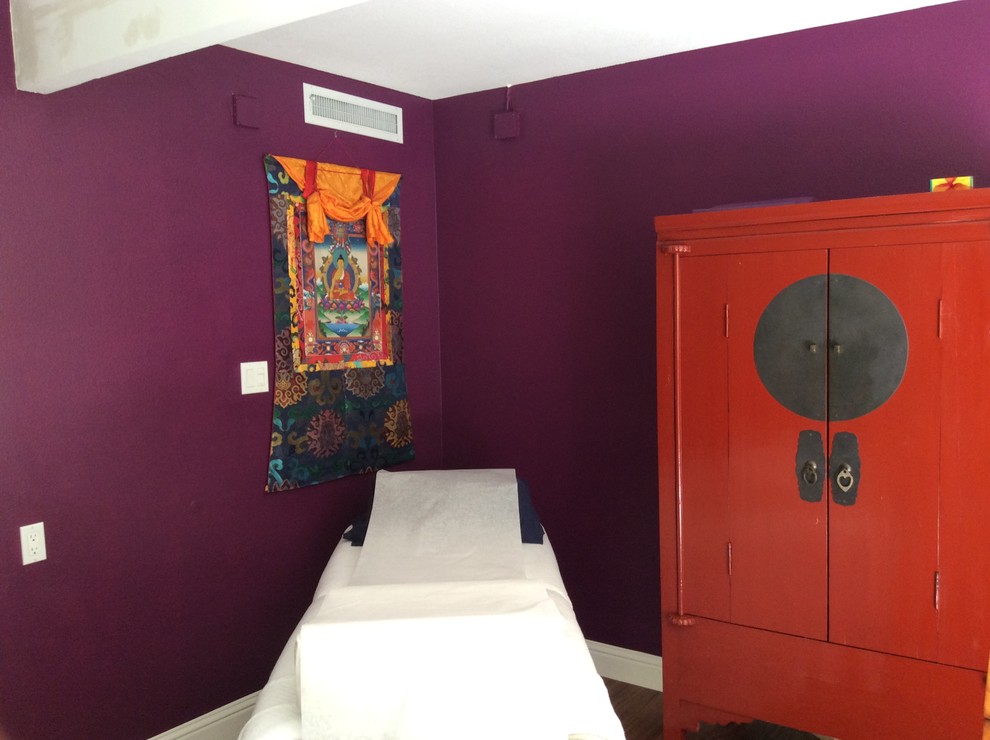 This is an example of a medium sized study in San Francisco with purple walls, dark hardwood flooring, no fireplace and a freestanding desk.