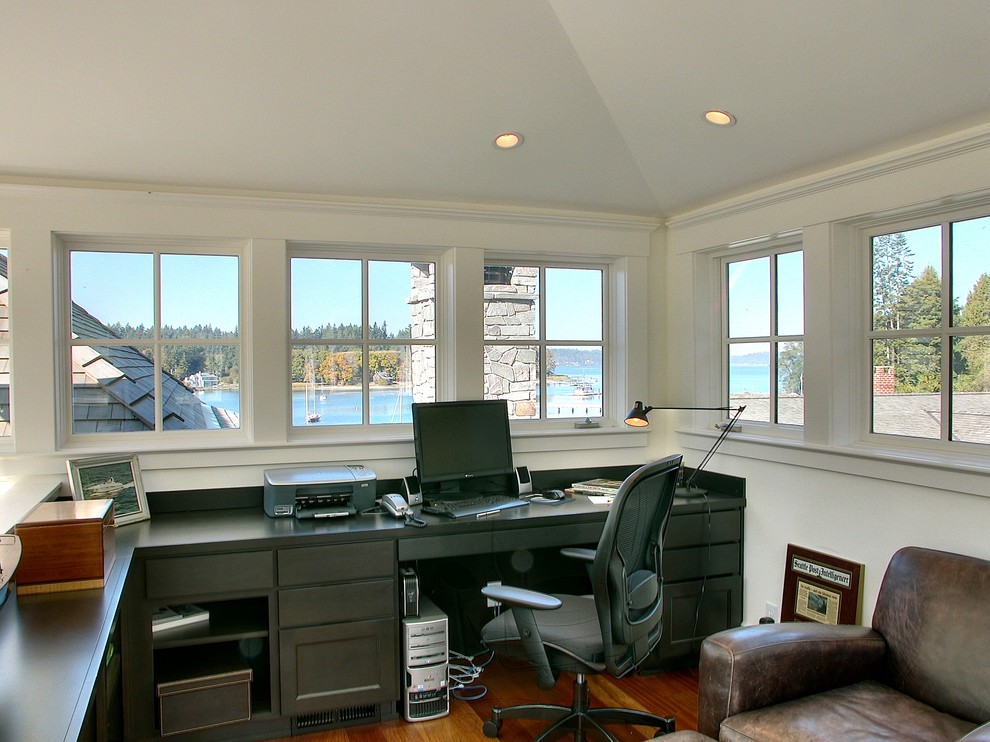 Traditional home office in Seattle with a built-in desk and white walls.