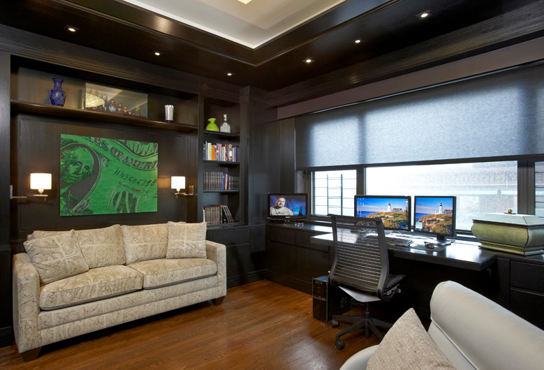 Medium sized contemporary home office in New York with dark hardwood flooring and a built-in desk.