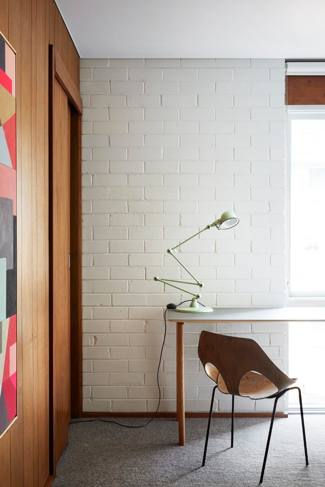 Стильный дизайн: маленькое рабочее место в современном стиле с белыми стенами, ковровым покрытием, отдельно стоящим рабочим столом и серым полом для на участке и в саду - последний тренд