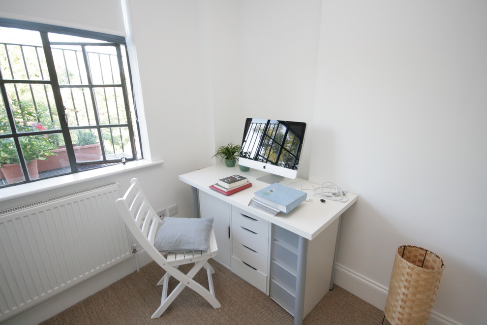 Photo of a contemporary home office in London with white walls.