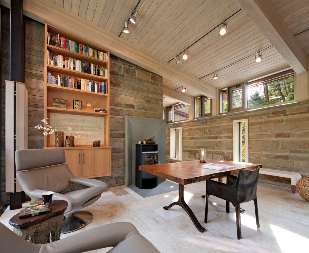 Idée de décoration pour un grand bureau design avec un poêle à bois, un bureau indépendant, un sol beige, un mur beige et un sol en travertin.