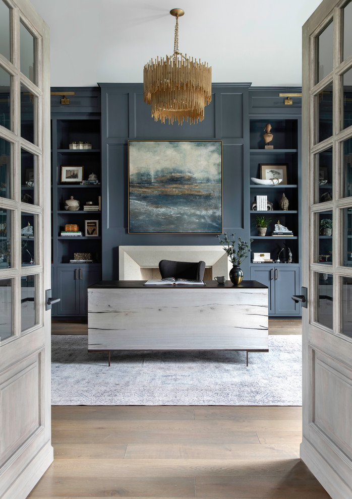 Inspiration for a huge transitional freestanding desk medium tone wood floor study room remodel in Houston with blue walls, a standard fireplace and a stone fireplace
