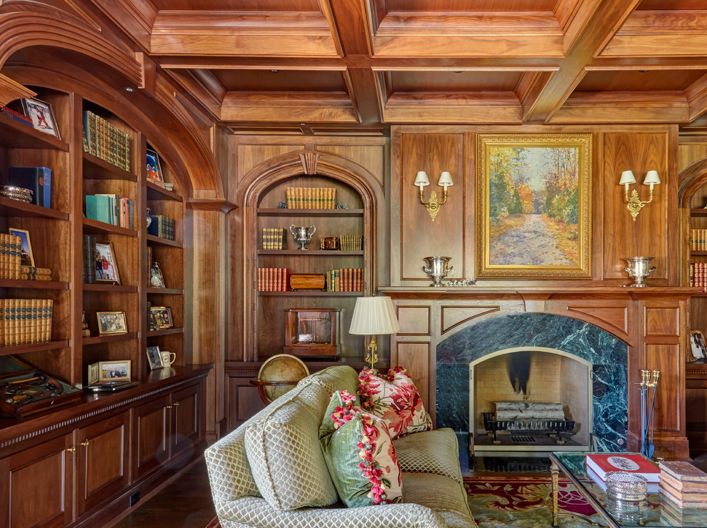 Cette image montre un très grand bureau traditionnel avec une bibliothèque ou un coin lecture, un mur marron, parquet foncé, une cheminée standard, un manteau de cheminée en pierre et un sol marron.