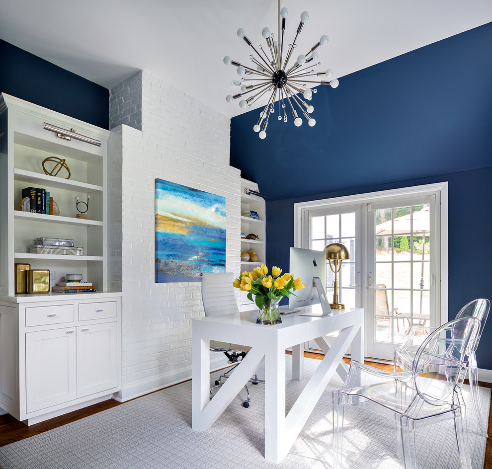 Imagen de despacho clásico renovado con paredes azules y escritorio independiente