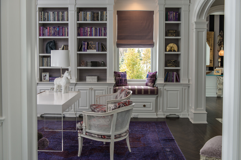 This is an example of a traditional study in New York with white walls, dark hardwood flooring and a freestanding desk.