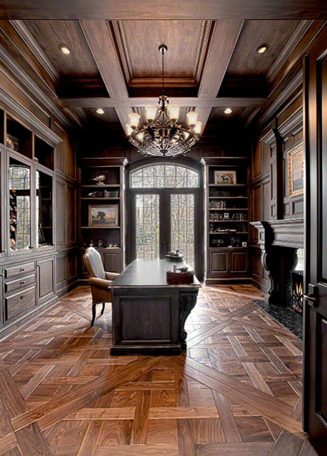 Idéer för stora rustika hemmabibliotek, med bruna väggar, mörkt trägolv, en standard öppen spis, ett fristående skrivbord och brunt golv