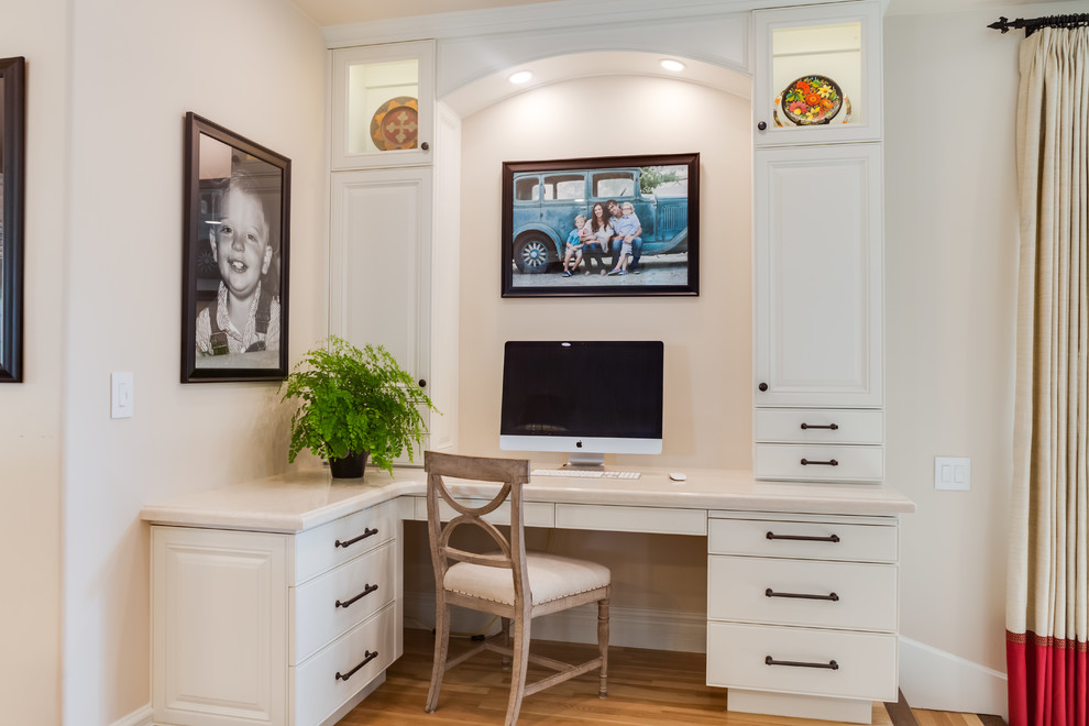 Inspiration for a medium sized classic home office in Sacramento with beige walls, light hardwood flooring, a built-in desk and beige floors.