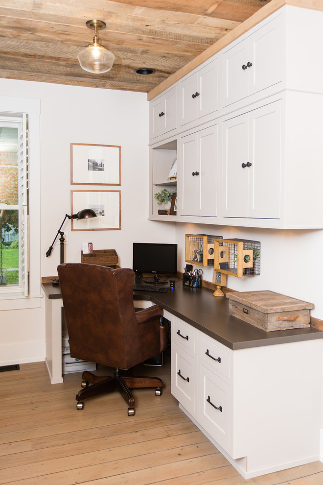 Home office - small farmhouse built-in desk light wood floor and brown floor home office idea in Columbus