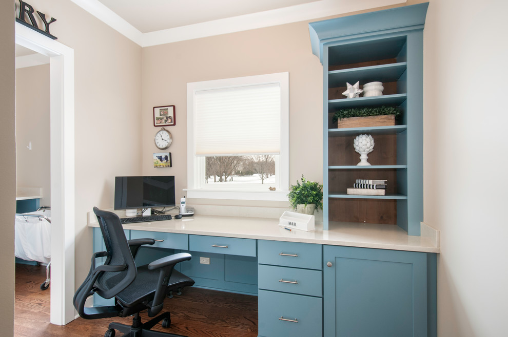 This is an example of a small classic home office in Chicago with beige walls, medium hardwood flooring, a built-in desk and brown floors.