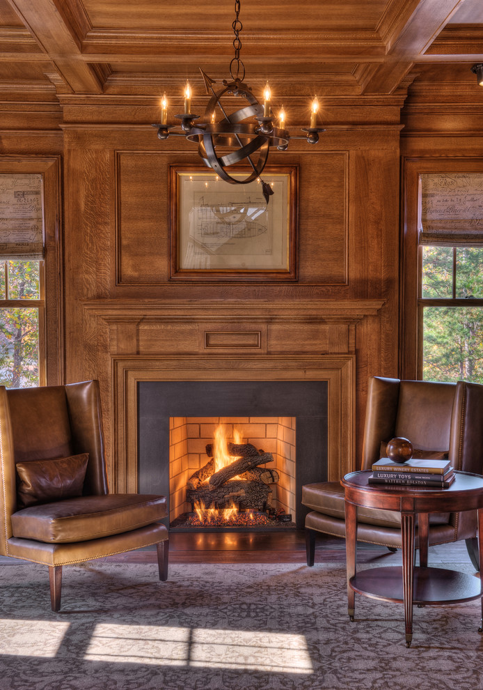 他の地域にあるトラディショナルスタイルのおしゃれなホームオフィス・書斎 (コンクリートの暖炉まわり、標準型暖炉) の写真