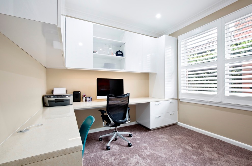 Example of a mid-sized trendy built-in desk carpeted study room design in Melbourne with beige walls and no fireplace