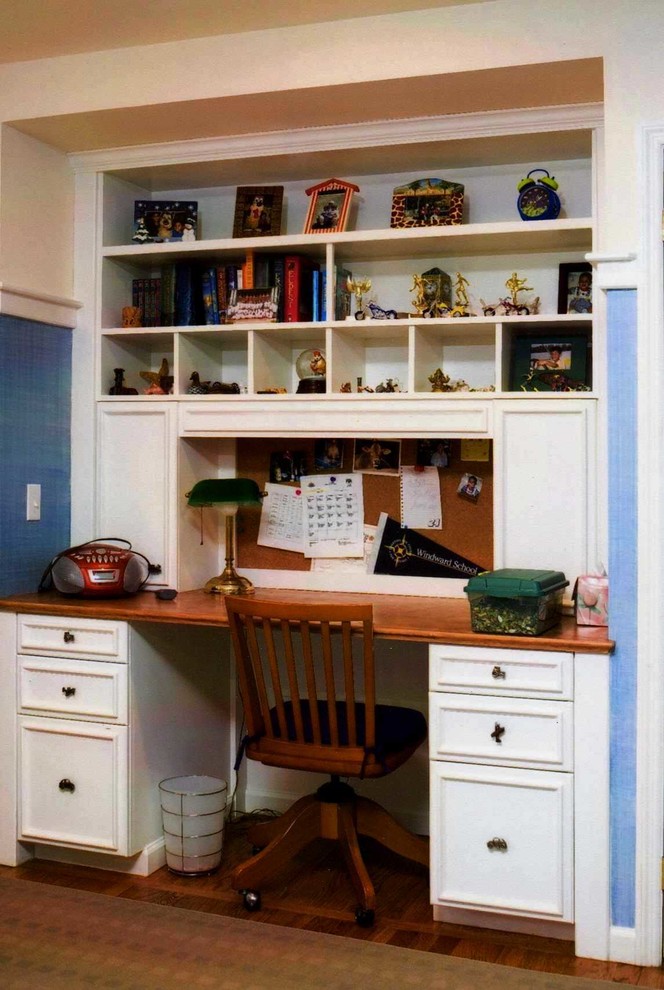 Small classic study in New York with blue walls, medium hardwood flooring, no fireplace and a built-in desk.