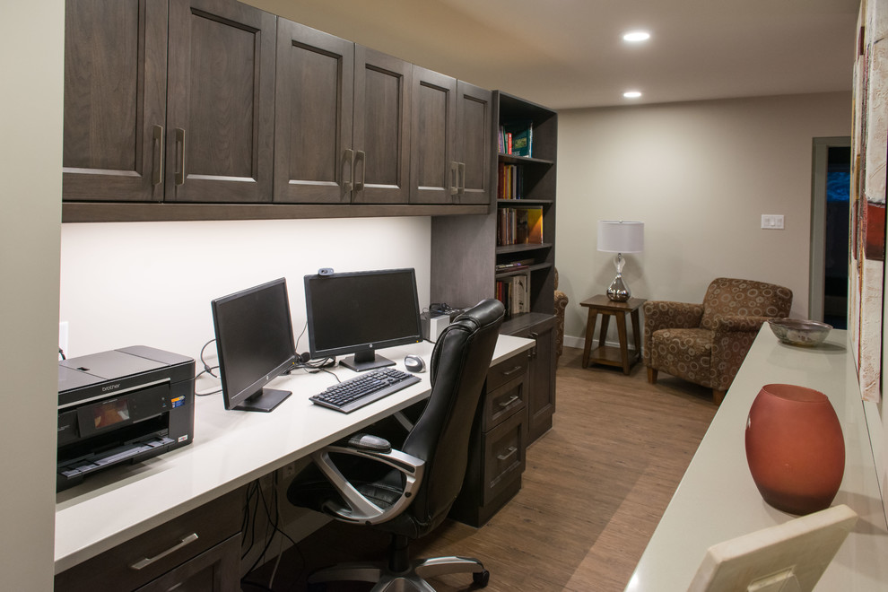 Example of a small transitional built-in desk vinyl floor home office design in Other with beige walls