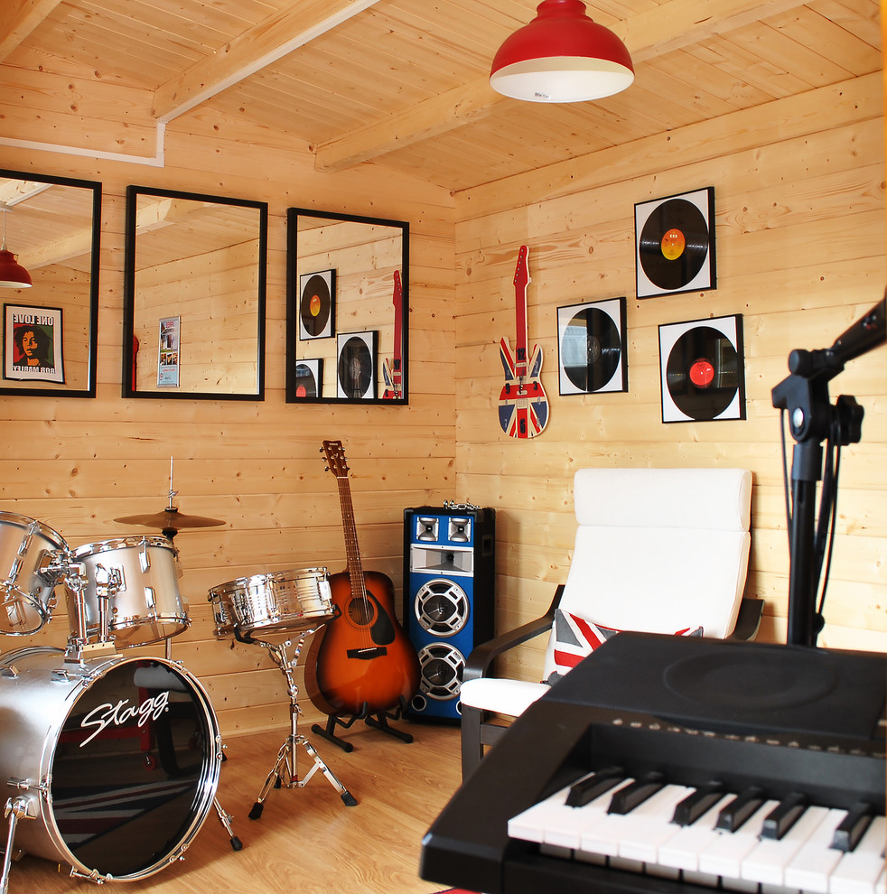 This is an example of a medium sized contemporary home studio in Kent with vinyl flooring and a freestanding desk.