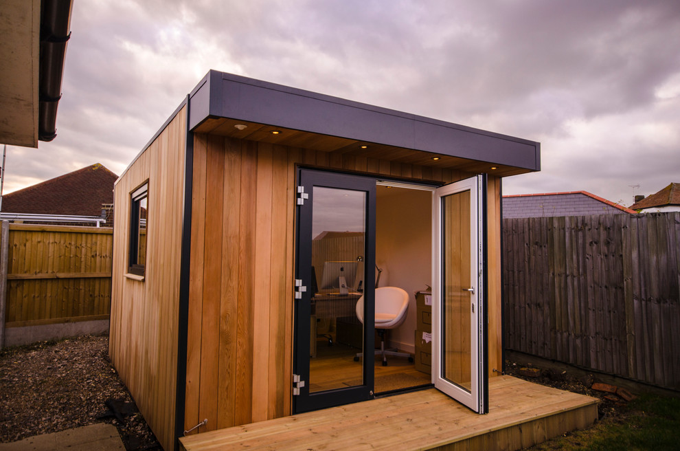 Home office - contemporary freestanding desk medium tone wood floor home office idea in West Midlands