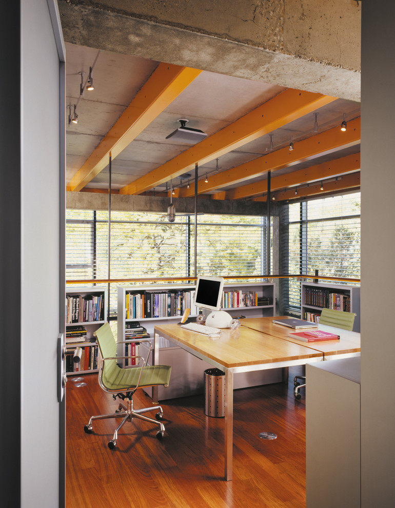 Home office - industrial freestanding desk medium tone wood floor home office idea in Chicago