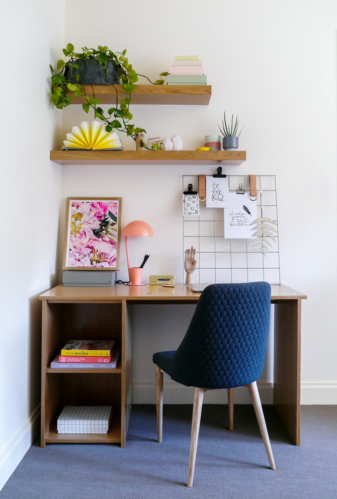 Trendy freestanding desk carpeted and blue floor home office photo in Melbourne with white walls