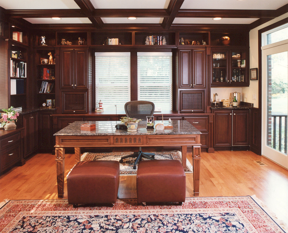 Example of a classic freestanding desk medium tone wood floor home office design in Chicago with white walls