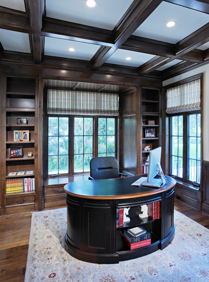 Elegant freestanding desk dark wood floor home office photo in Chicago