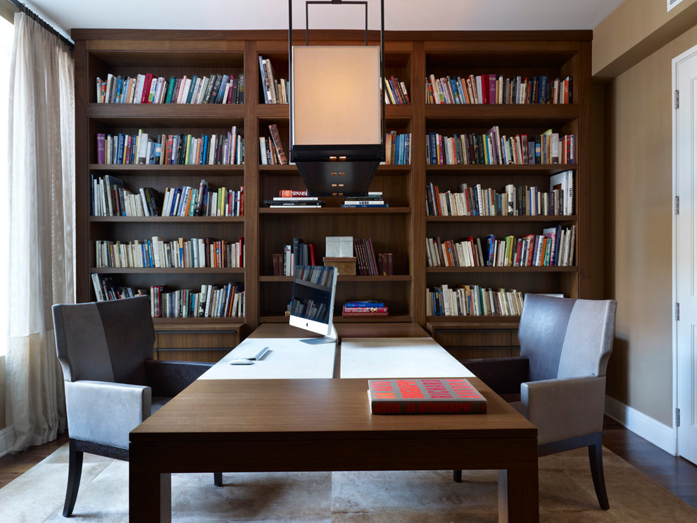Home office - contemporary built-in desk dark wood floor home office idea in Chicago with brown walls