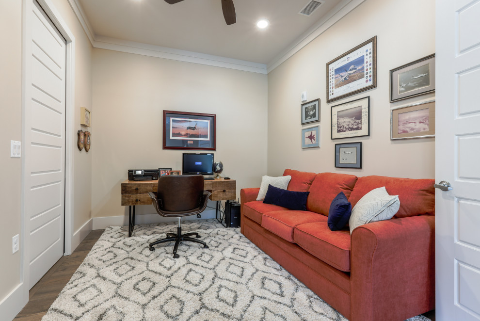 This is an example of a medium sized traditional study in Denver with beige walls, medium hardwood flooring, no fireplace, a freestanding desk and brown floors.