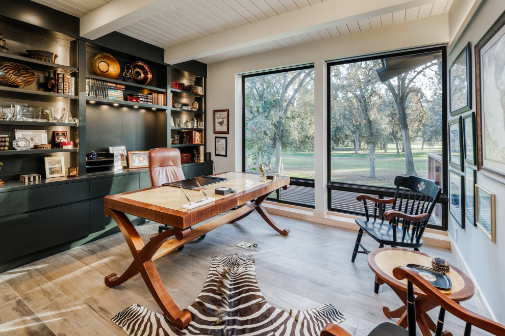 Photo of a large study in Sacramento with a freestanding desk, exposed beams, a timber clad ceiling, porcelain flooring, beige floors and white walls.