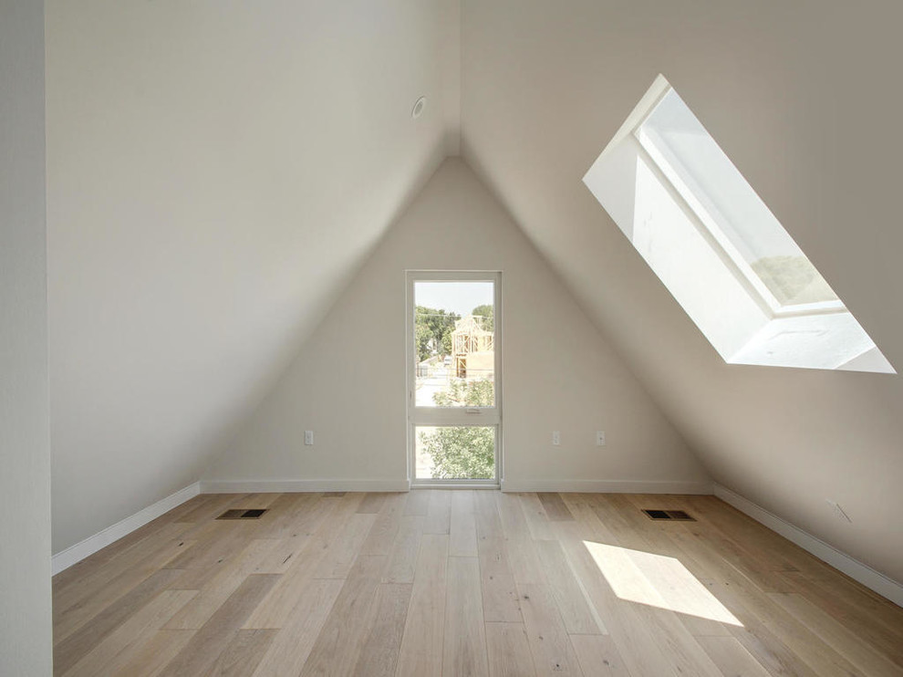 Photo of a medium sized modern home studio in Austin with white walls, light hardwood flooring and no fireplace.