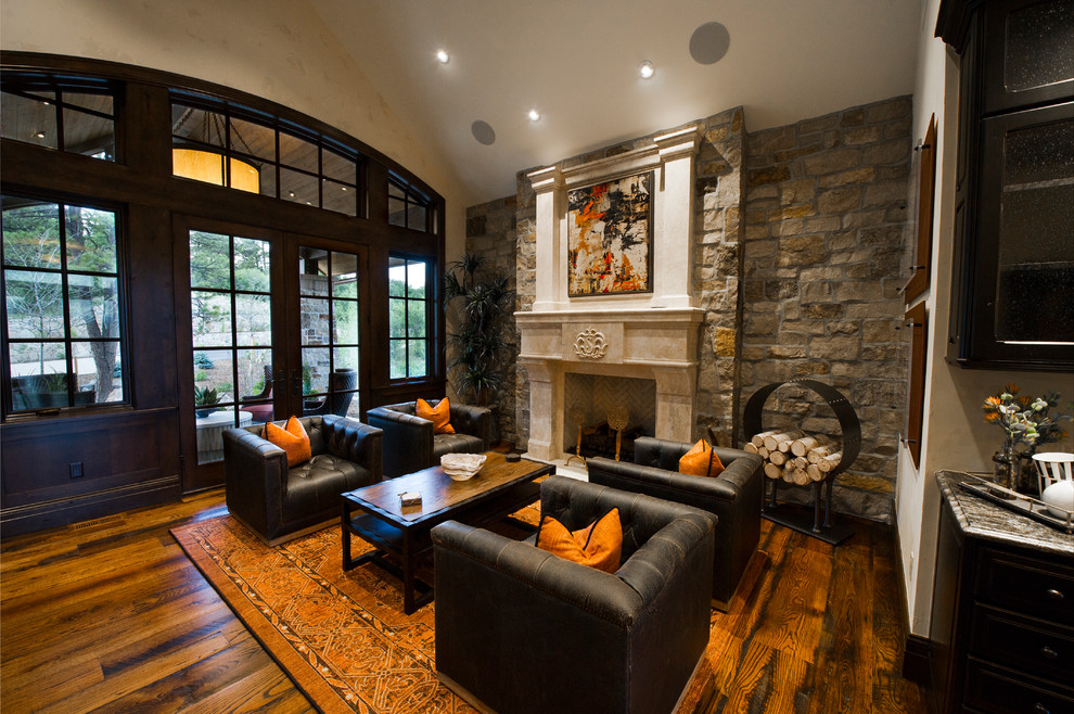 Study room - large rustic freestanding desk medium tone wood floor and brown floor study room idea in Denver with white walls, a standard fireplace and a stone fireplace