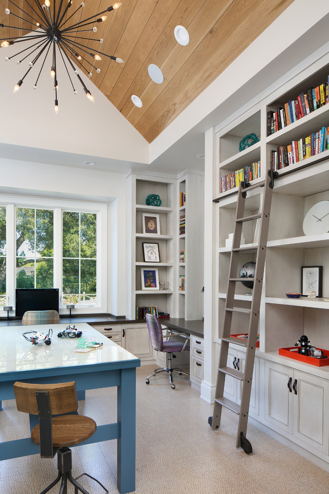 This is an example of a classic home office in San Francisco with white walls, a freestanding desk and beige floors.