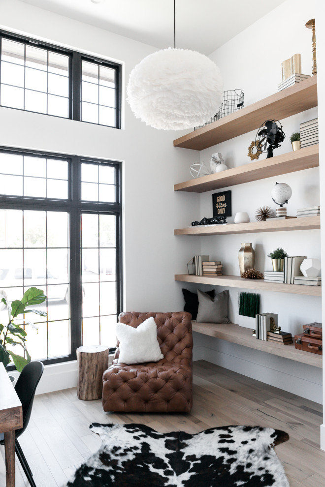 Design ideas for a scandi home office in Denver with white walls, medium hardwood flooring, a freestanding desk, brown floors and feature lighting.