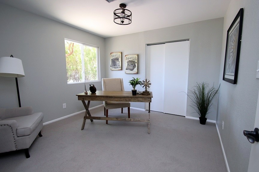 Photo of a classic home office in Phoenix with carpet, no fireplace and a freestanding desk.