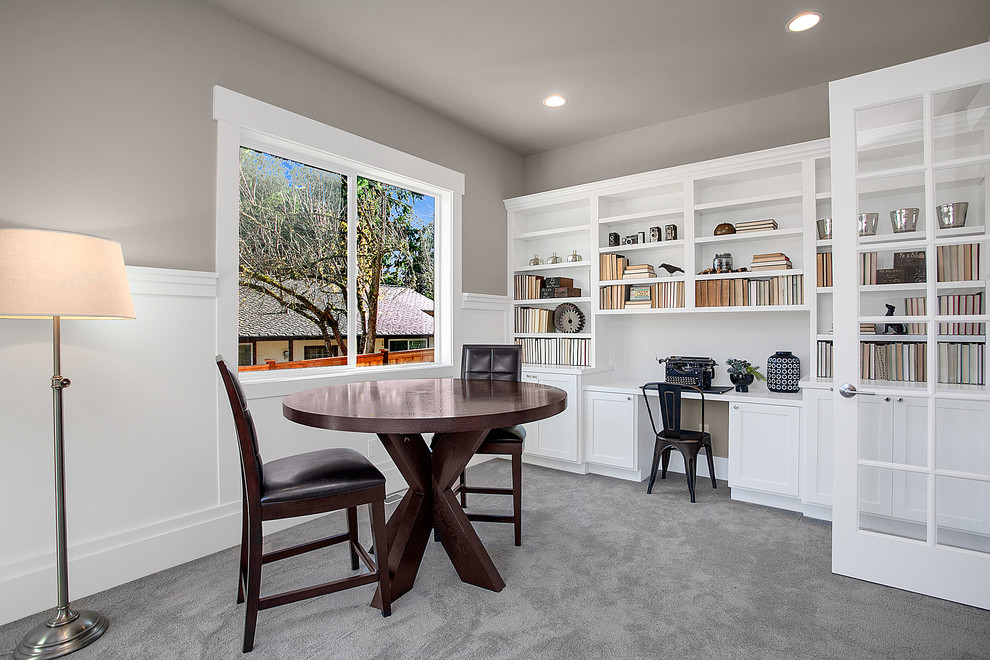 Example of a mid-sized arts and crafts built-in desk carpeted study room design in Seattle with gray walls and no fireplace