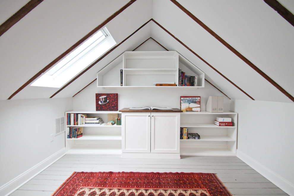 Inredning av ett lantligt mellanstort hemmabibliotek, med vita väggar, målat trägolv, ett inbyggt skrivbord och grått golv