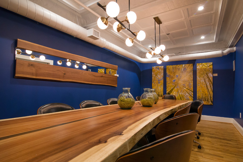 Immagine di un'ampia sala da pranzo con pareti blu