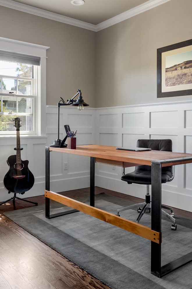 Mid-sized elegant freestanding desk dark wood floor home studio photo in Seattle with beige walls