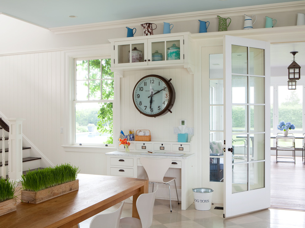 Example of a small transitional built-in desk painted wood floor study room design in New York with white walls