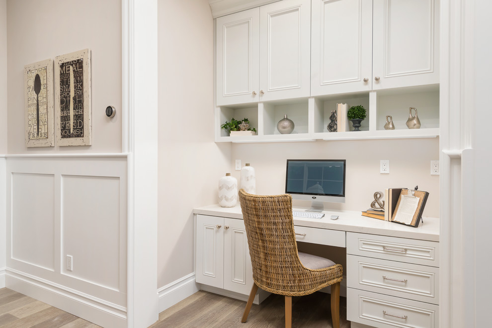 Foto de despacho tradicional sin chimenea con paredes grises, suelo de madera en tonos medios y escritorio empotrado