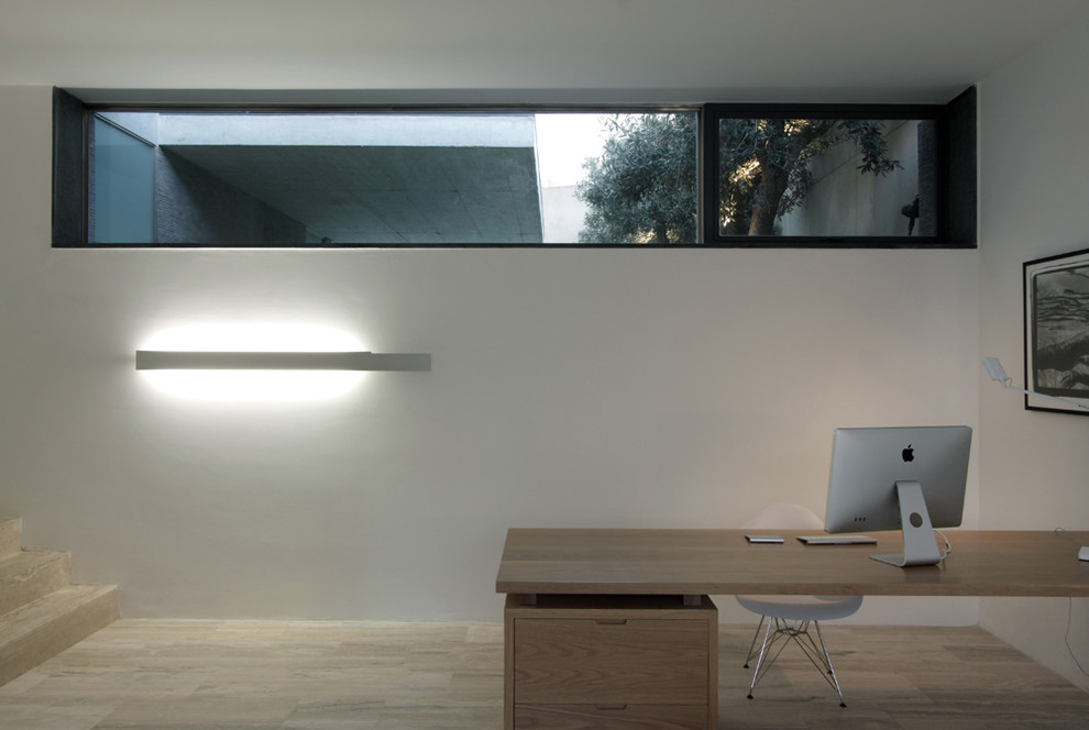 Diseño de despacho actual con paredes blancas y escritorio independiente