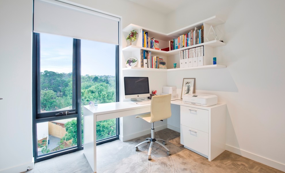 Photo of a small contemporary study in Melbourne with a built-in desk, white walls, carpet and no fireplace.