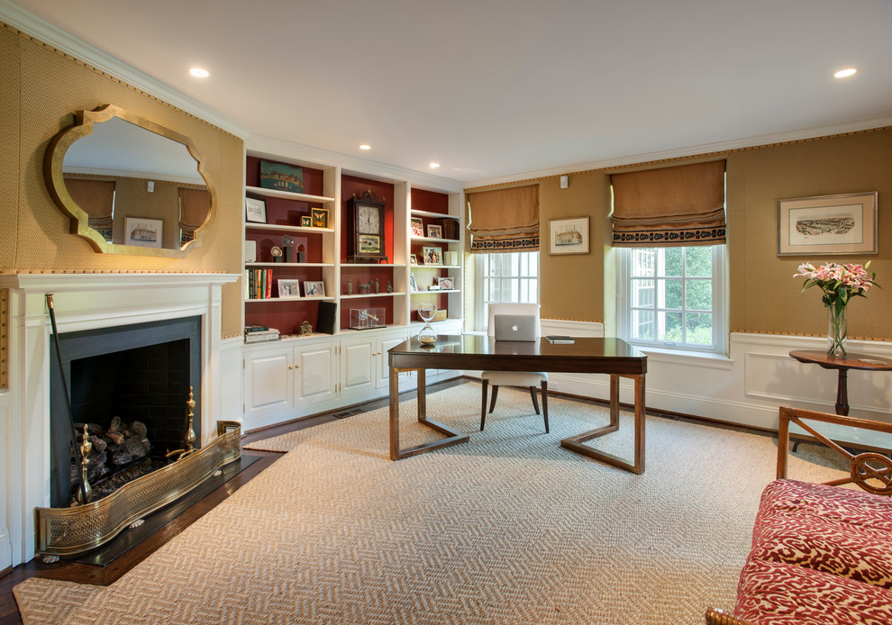 Inspiration for a large classic study in Philadelphia with carpet, a standard fireplace, a freestanding desk, a stone fireplace surround and brown walls.
